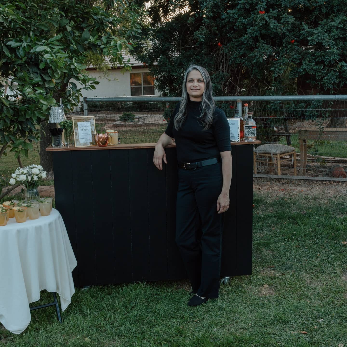 Beth, owner and lead bartender of The Sonoran Pour, working behind a portable bar at a private event