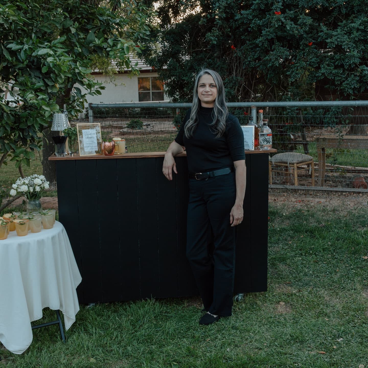 Beth, owner and lead bartender of The Sonoran Pour, working behind a portable bar at a private event